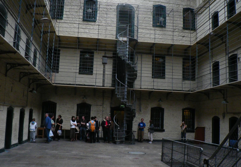 a group of people standing in an old - fashioned building