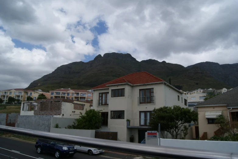 an apartment building in a neighborhood surrounded by mountains