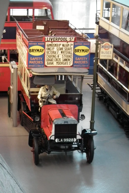 old model cars are displayed at a museum