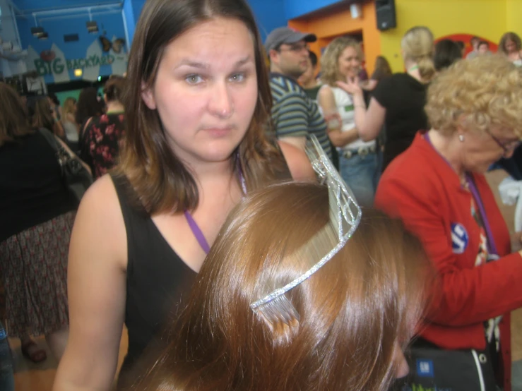 two women look concerned at a hair comb competition
