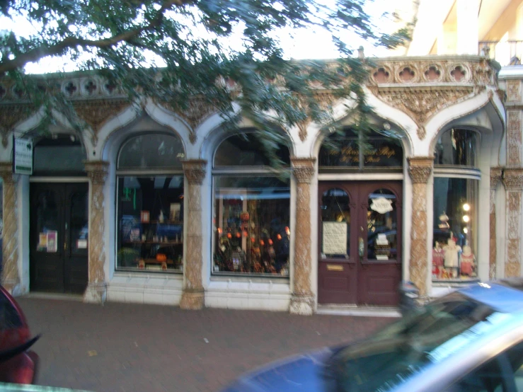 the shop front is painted brick and ornate
