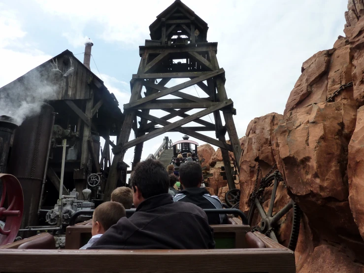 a view from behind the bench, with people walking down the walkway looking at an exhibit