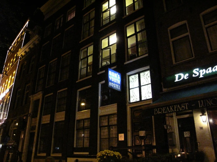 a nighttime s of a building with a logo