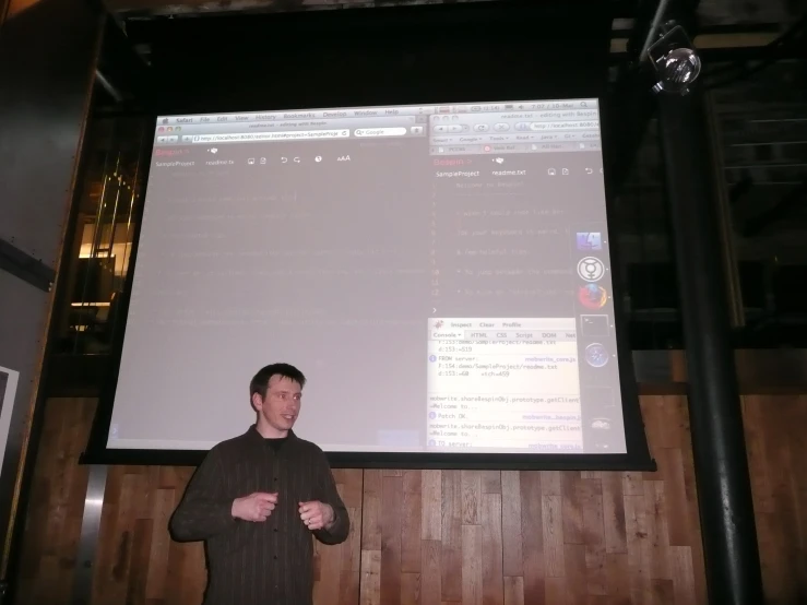man standing by wall displaying menu on large projector screen