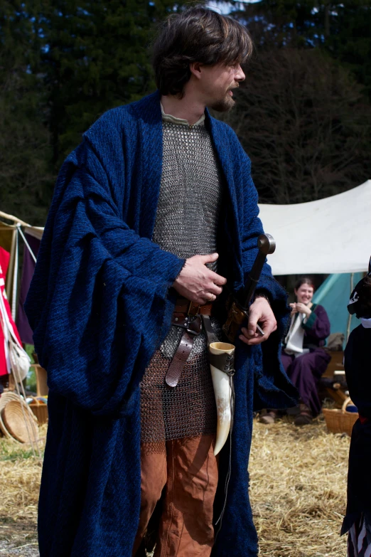 a man in a medieval style robe is talking to someone