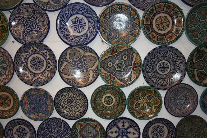 a wall mounted with decorative plates on display