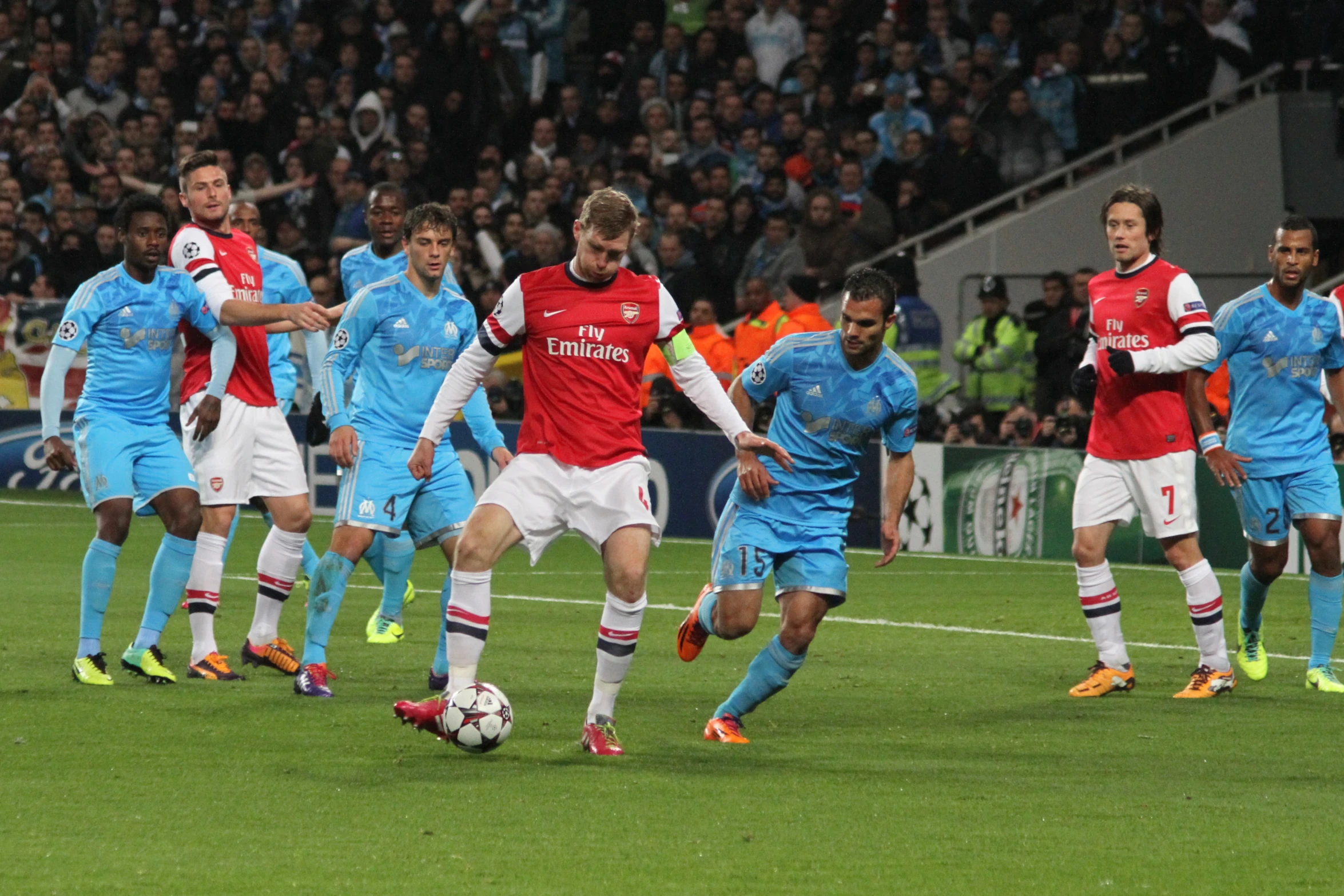 a soccer team of men kicking a ball during a game