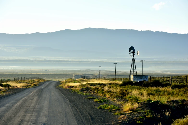 there is a dirt road in the middle of a barren area