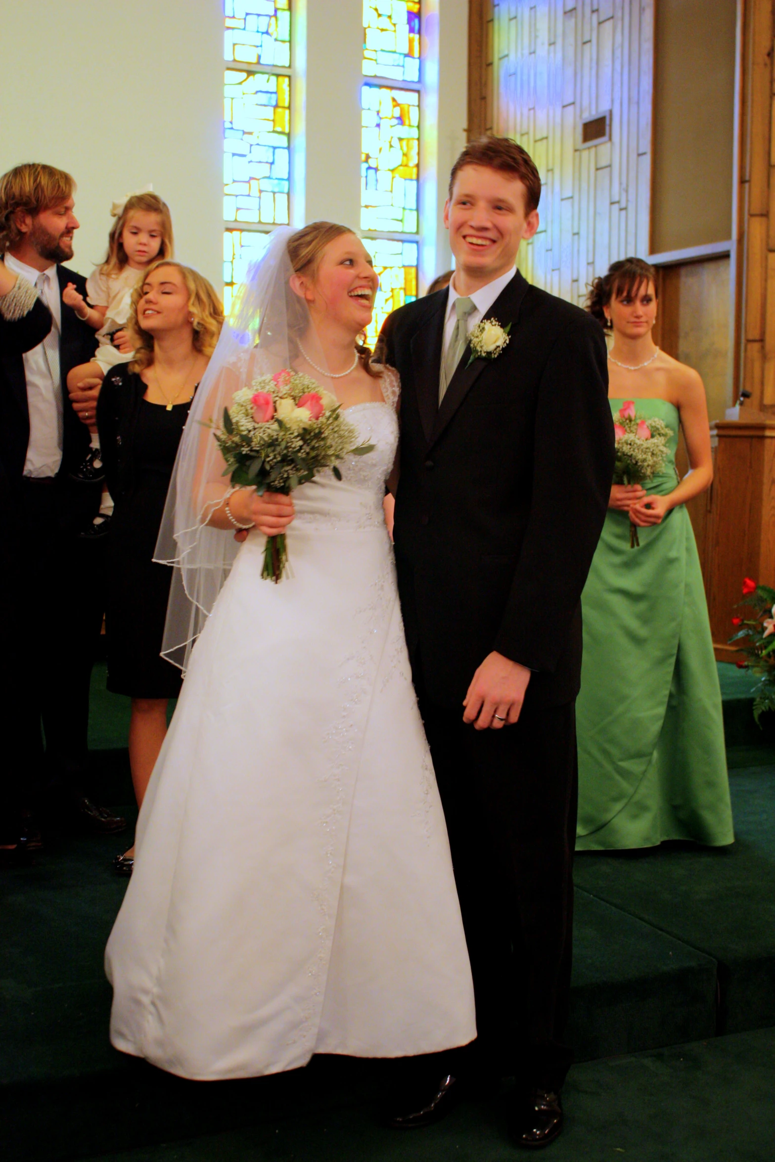 two people posing for a picture as they are at a ceremony