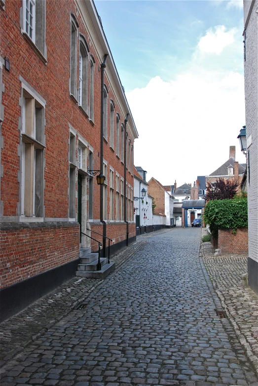 cobble stone street with old buildings in a city