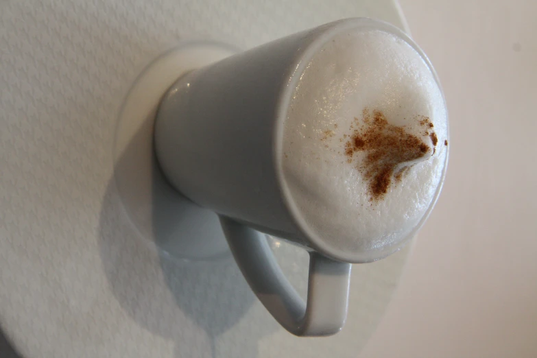 a white cup with some sugar on top