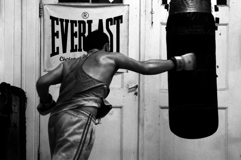 a man standing in front of a punching bag