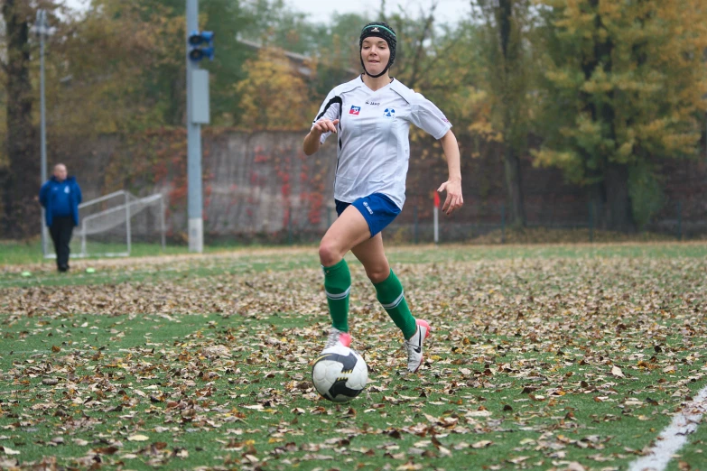 a women's soccer player moves along the field