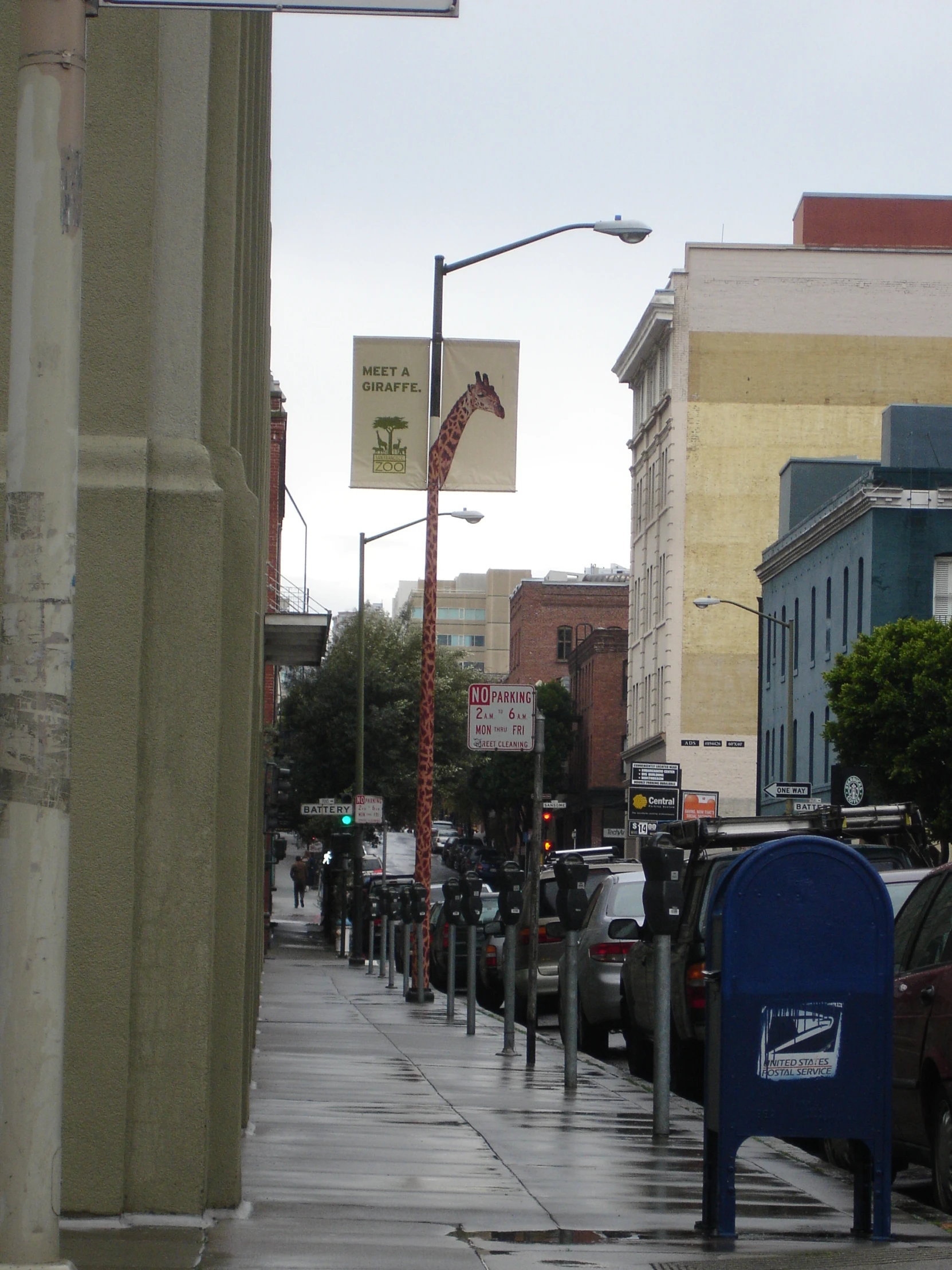 the sidewalk near the curb has many cars parked on it