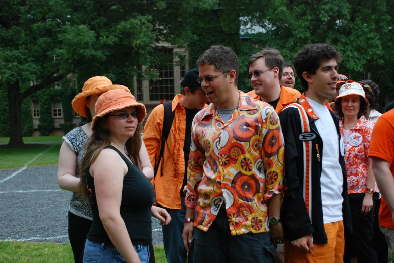 some people and one is wearing an orange hat