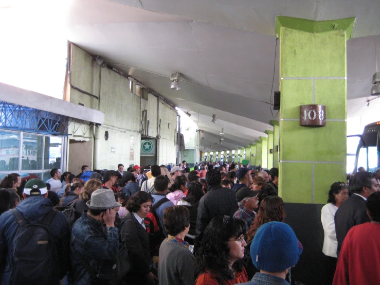 large group of people standing in a building