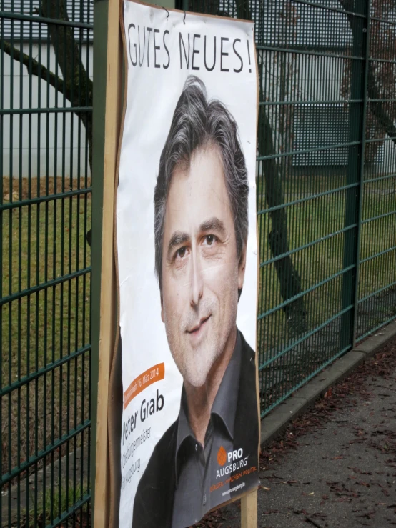 an advertit for a campaign on the side of a fence