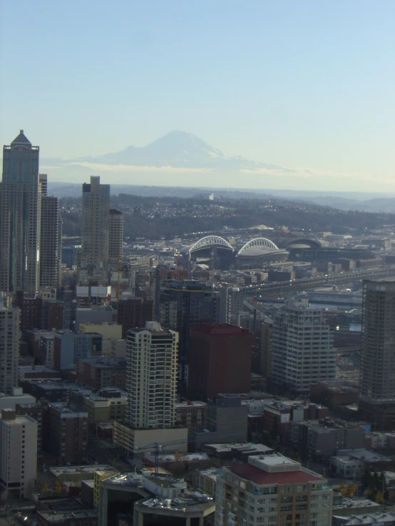 an overview view of a city with the mountain in the distance