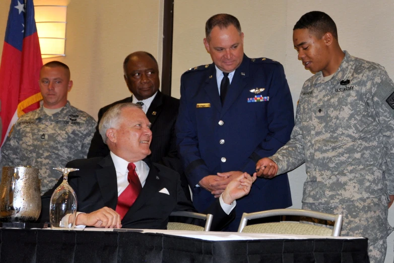 an image of military man being awarded in office