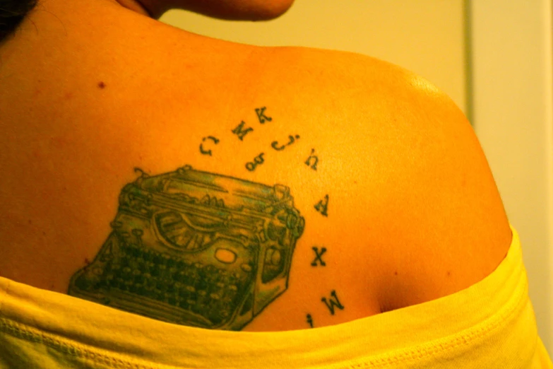 a person with a back tattoo, with a typewriter