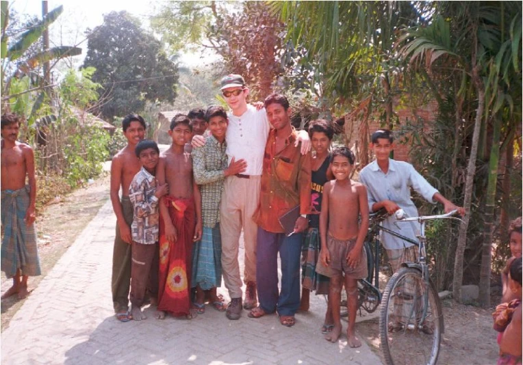 man standing next to a bunch of children