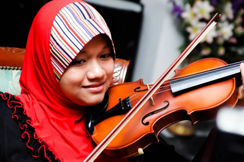 a woman in colorful dress playing the violin