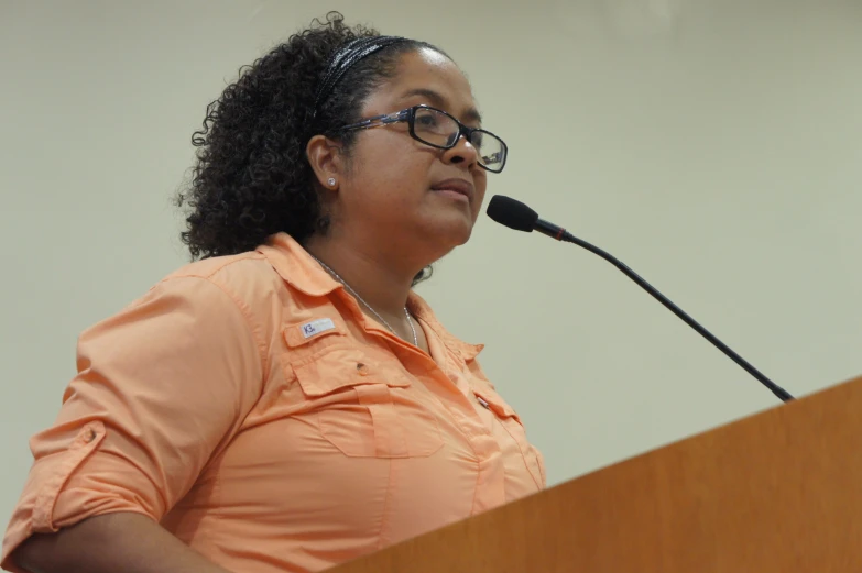 the woman is speaking from a podium