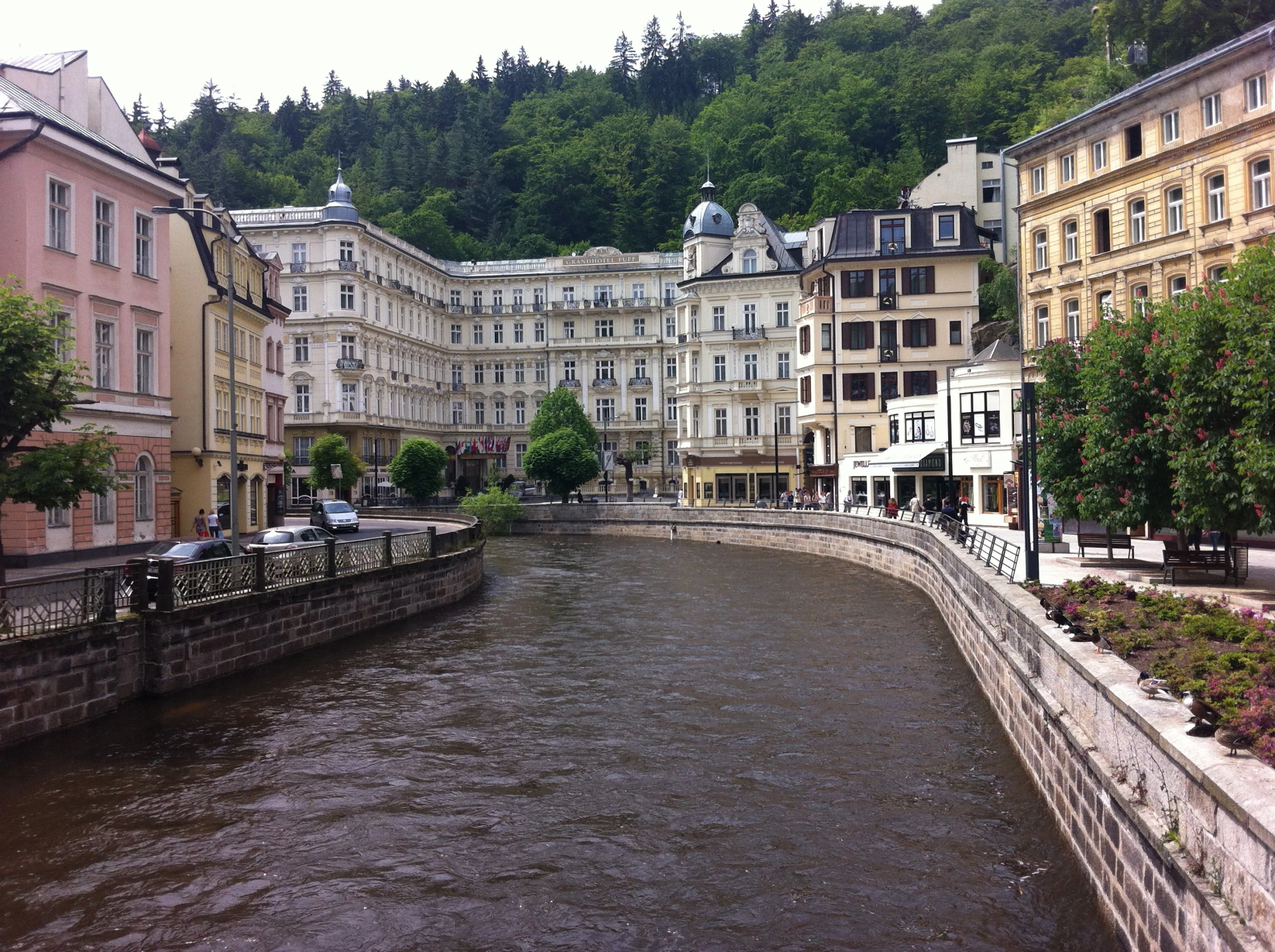 an urban river is seen with buildings on the side