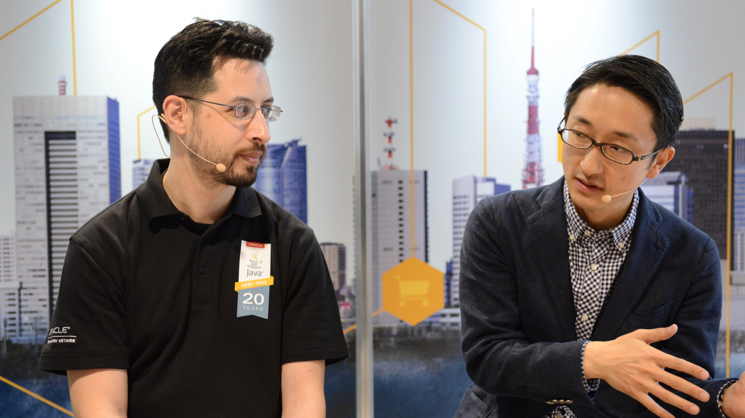 a man talking to another man in front of a city skyline