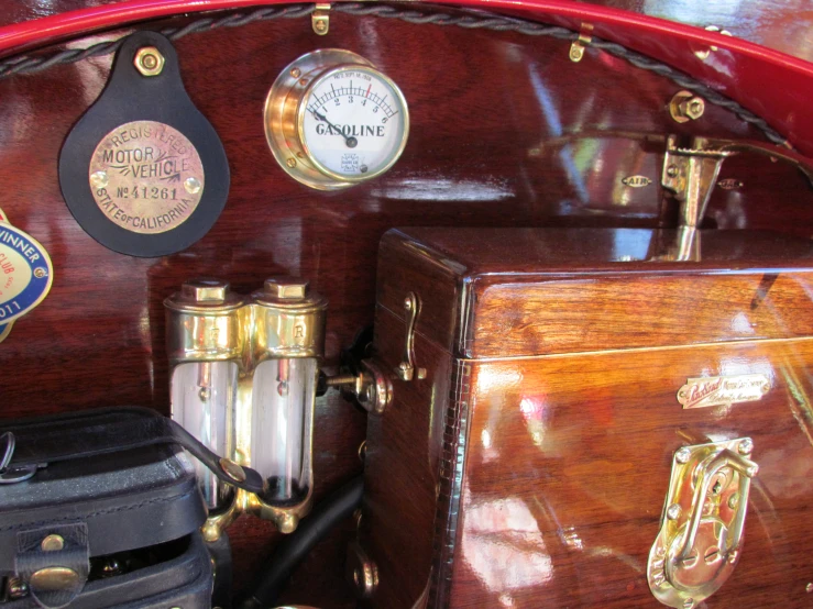 old fashioned clocks and suitcases sitting on the back of a boat