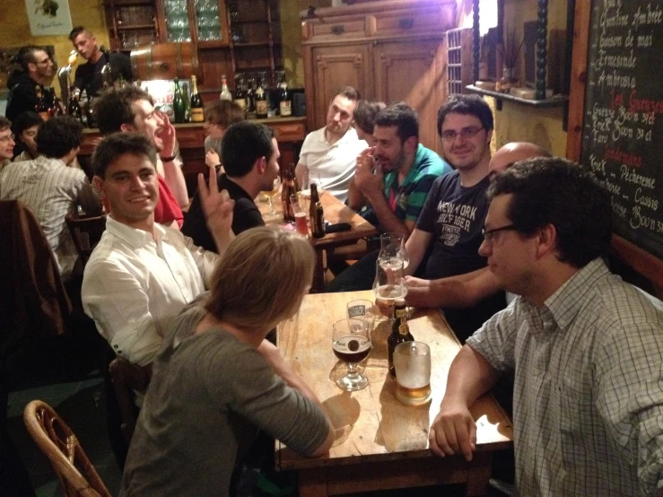 a bunch of people sitting at a restaurant table