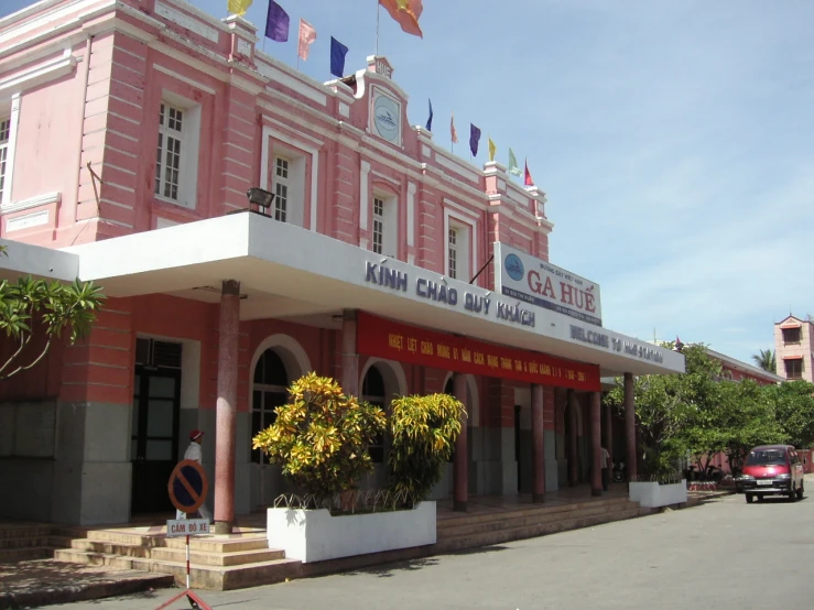 the main entrance to a chinese business with a flag on the side