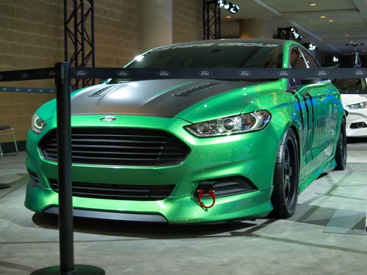 the green mustang mustang is sitting in the showroom
