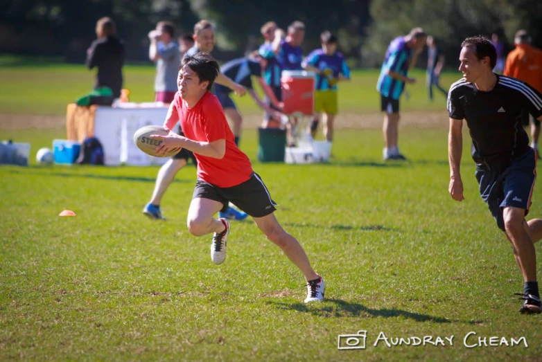 two people running with a ball during a frisbee game