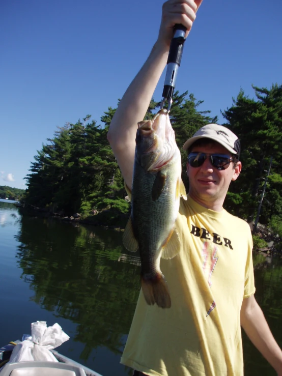 a man holding onto his fish while on the water