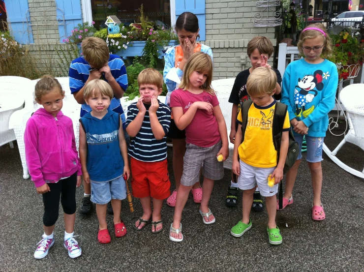 a bunch of s posing for a picture on the sidewalk