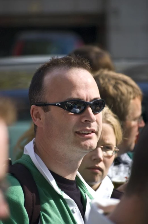 a man in a green shirt with sunglasses