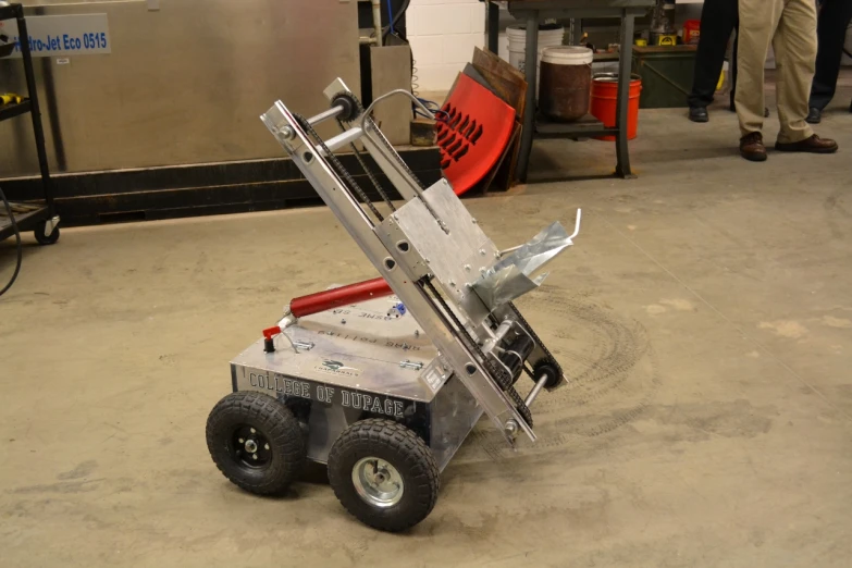 a dolly attached to a metal cart in a factory