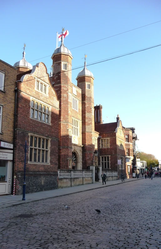 the building features two clock towers, and an old red brick building