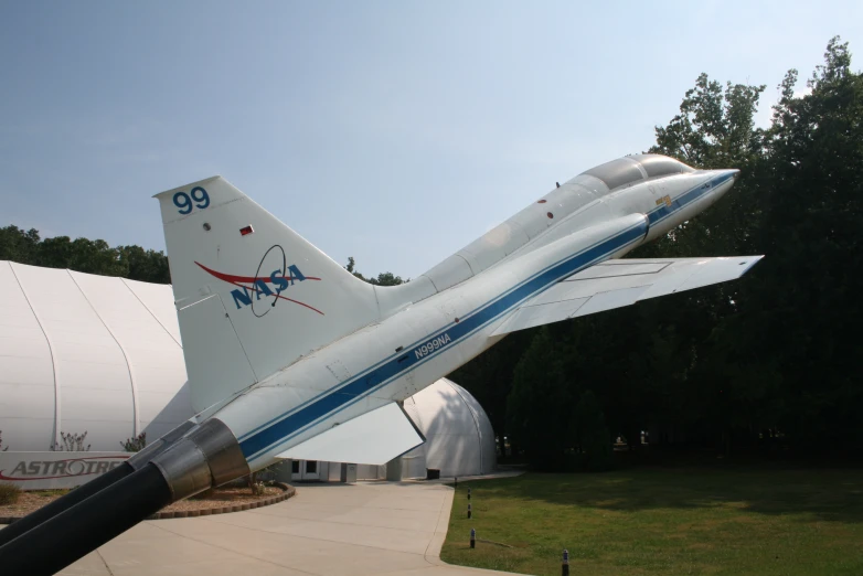 an airplane with a red blue and white tail parked on top of it's side