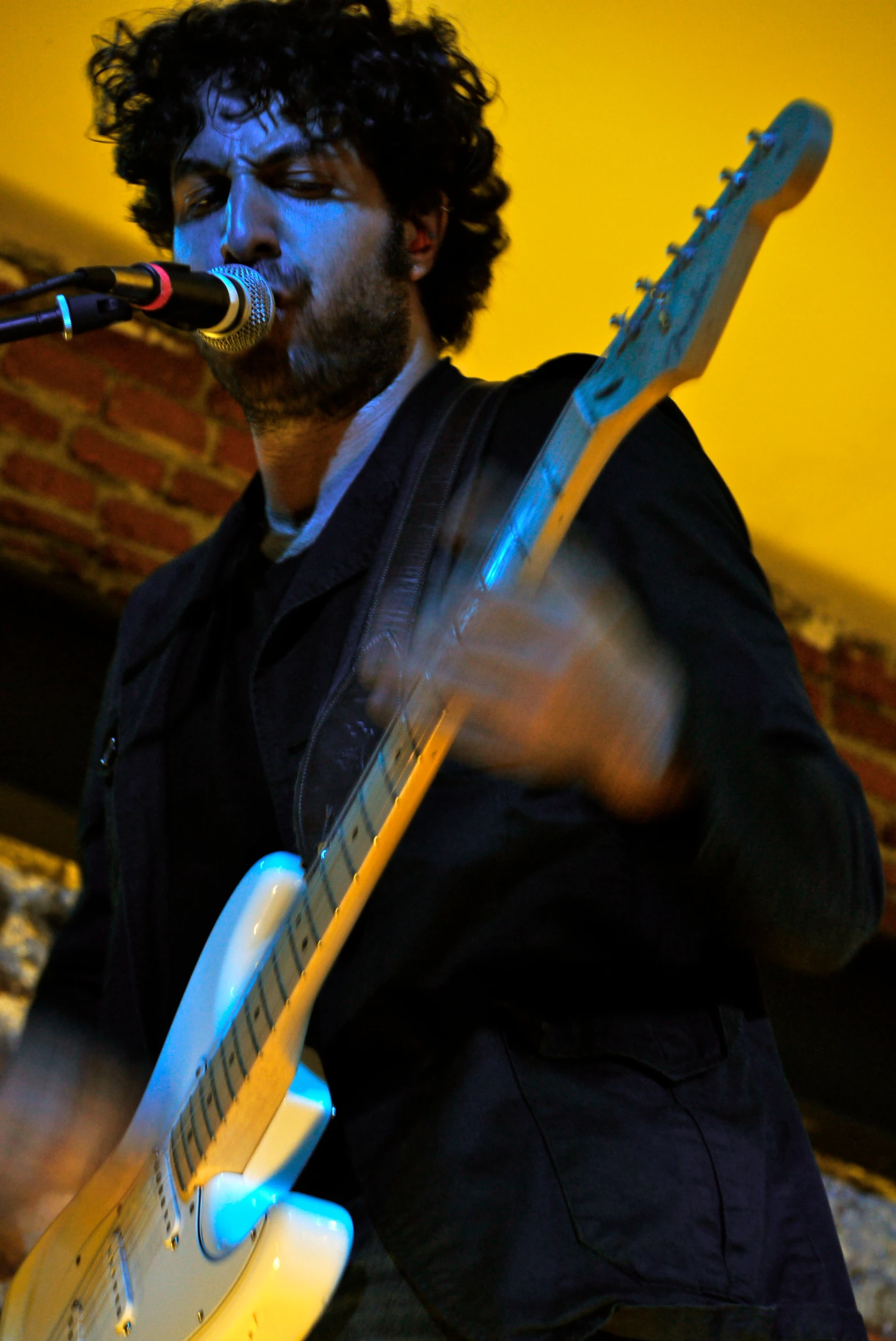 a man holding a guitar on a stage