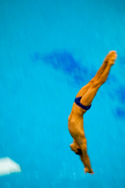 a man diving in the water from a boat