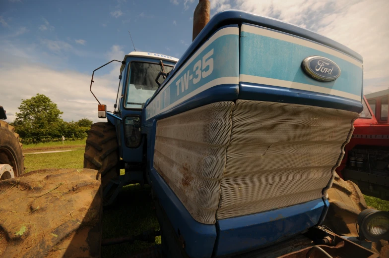 a large blue tractor in a farm field