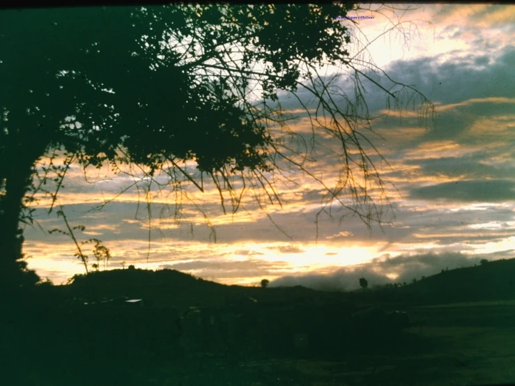 the silhouettes of people on the hill against the sky