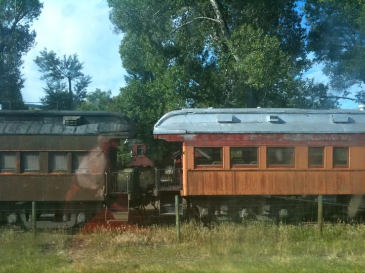 an old fashioned train sitting on the tracks