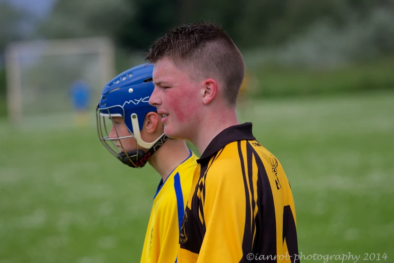 a  wearing a catchers mask looking over his shoulder