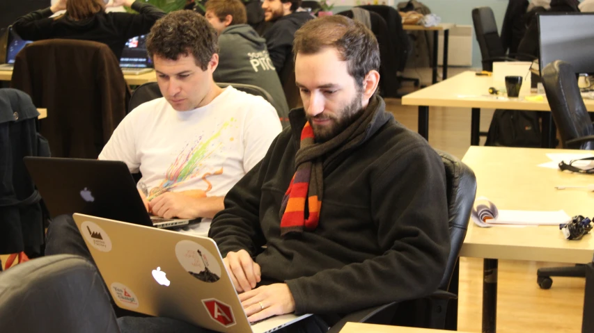 a man with a beard looking at a laptop