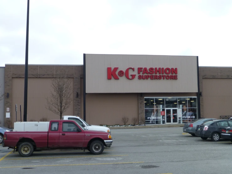 a kfc fashion supply store with several cars parked outside