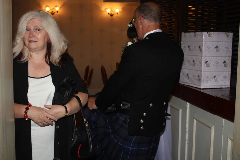 a man in a kilt and his wife at a wedding