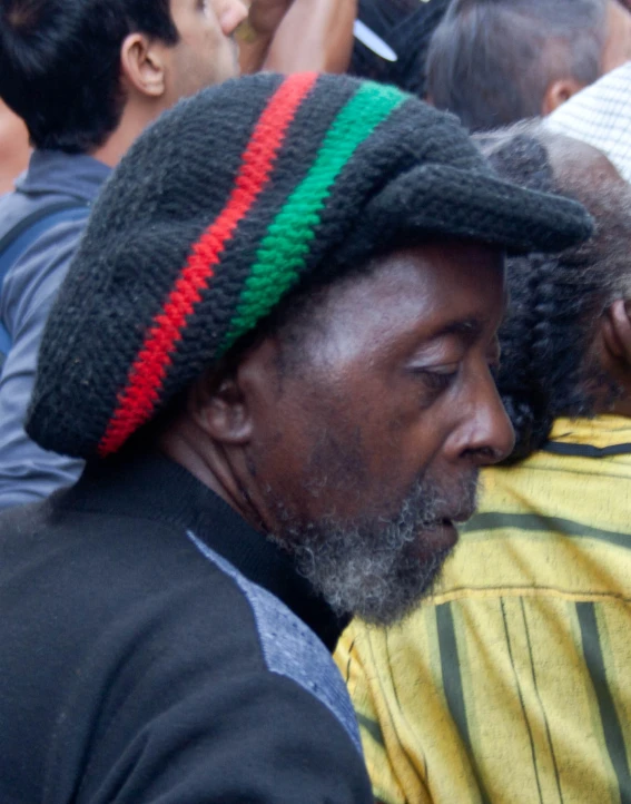 a man with a red, green and red striped hat